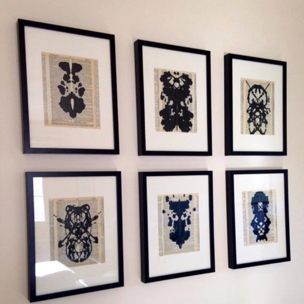 Six unframed inkblot paintings on dictionary paper